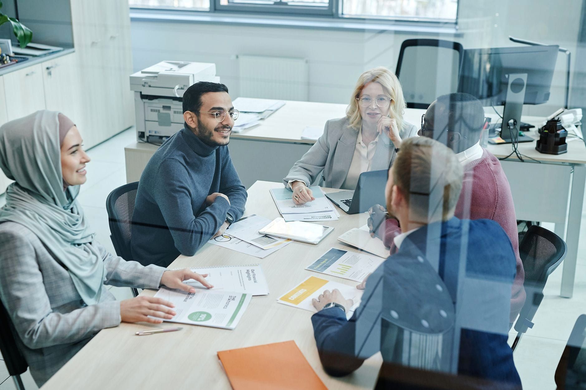 A professional team in a meeting around a table.